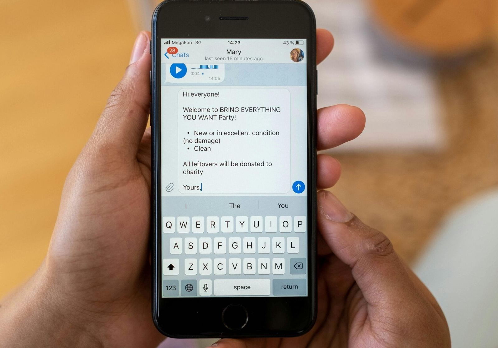 Hand holding a phone with a chat open